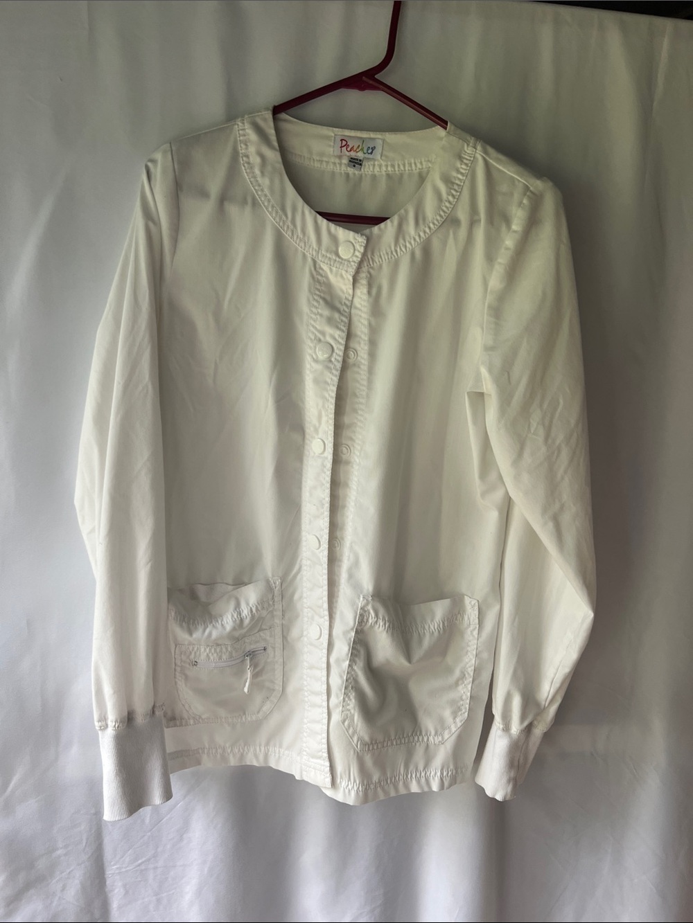 Women's White Button-Up Medical Scrub Jacket by Peaches.